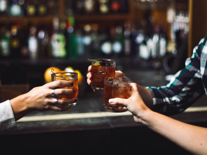 friends toasting with cocktails